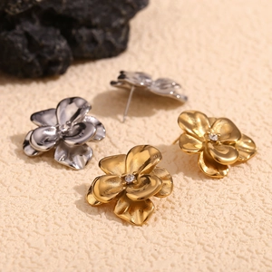 Elegant 18K gold and silver double-layered floral stud earrings with crystal centers
