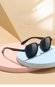 Detailed view of kids square sunglasses with black matte frames on display stands