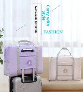 Detail of travel bags in purple and beige showing the luggage handle sleeve feature