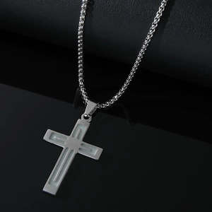 Luminous stainless steel cross pendant necklace with metallic chain on dark reflective surface