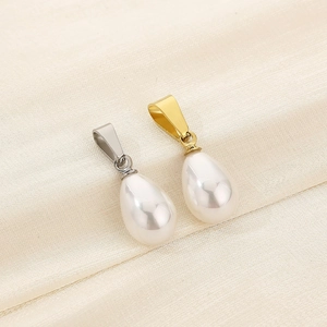 Detailed macro of white teardrop pearl pendants with gold and silver metal clasps