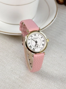 Detail of pink leather strap and gold watch case with white Roman numeral dial