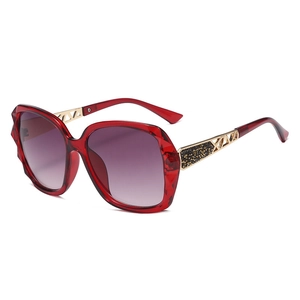 Women's oversized polarized sunglasses with transparent red frames and purple gradient lenses