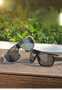 Close-up of oversized cycling sunglasses with streamline temples on a wooden surface