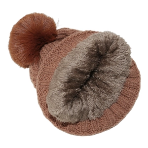 Detail of warm winter knit beanie showing thick grey fleece lining and large brown pom-pom