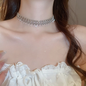 Detailed view of silver choker necklace featuring shimmering tassels and marquise zircons