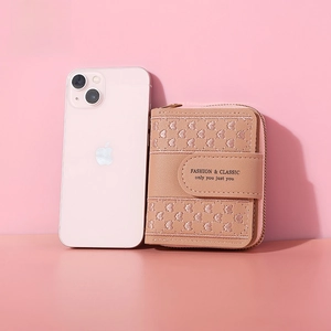 Pink heart-embroidered short wallet with zipper, shown next to a phone for size reference