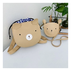 Detail of cute bear crossbody bag with pebble grain leather and drawstring lining