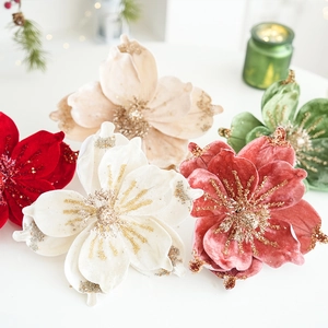 Macro detail of velvet magnolia flower heads with shimmering gold glitter on red petals