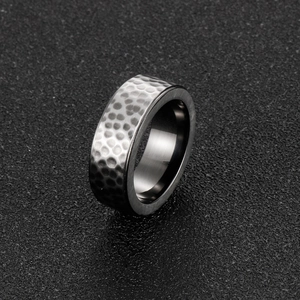 Macro detail of 8mm titanium steel ring showing textured hammered finish and polished edges
