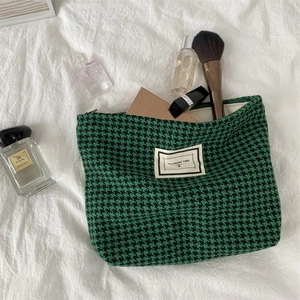 Classic green houndstooth makeup bag with soft fabric and top zipper closure
