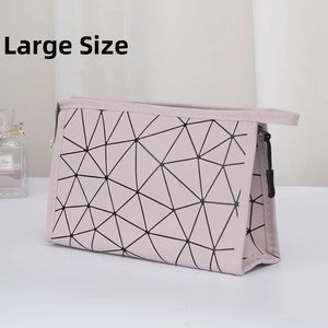 Large capacity pink PU leather makeup bag with black geometric lines and top handle