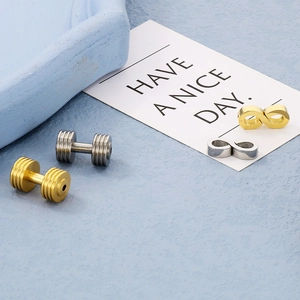 Macro detail of gold and silver dumbbell and infinity symbol charms for DIY jewelry making