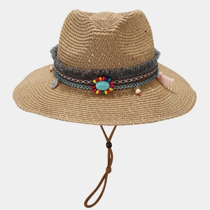 Detail of bohemian straw hat with turquoise beads, colorful tassels and wind rope