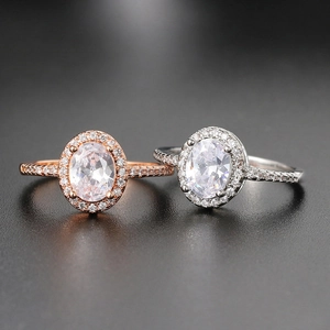 Classic oval cut halo engagement rings in rose gold and silver finish with pave zircons