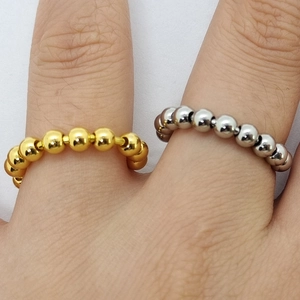 Polished gold and silver stainless steel beaded rings worn on fingers for anxiety relief
