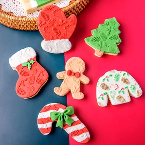 Christmas cookie molds set featuring gingerbread man and stocking embossed shapes