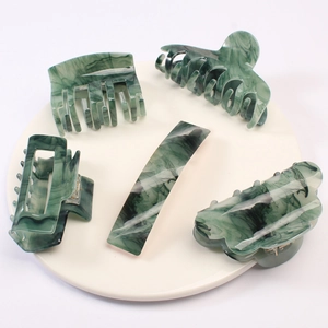 5-piece green marble acetate hair clip set with hair claws on a round display plate