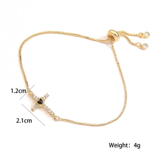 Detailed view of 18K gold plated cross bracelet with black heart gem and size measurements
