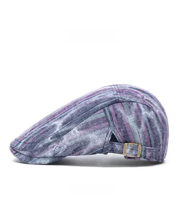 Side view of striped flat cap with adjustable bronze metal buckle and textured fabric
