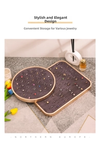 Detailed view of jewelry display trays with golden metal frames and gray velvet foam slots