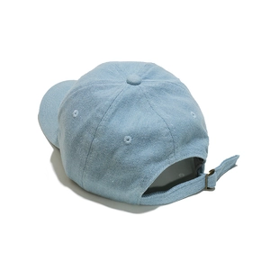 Detail view of light blue corduroy baseball cap showing adjustable strap and metal buckle