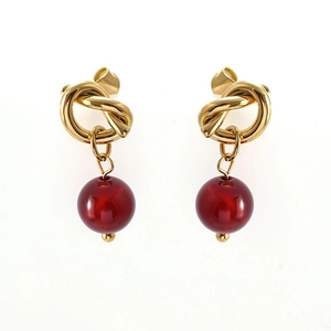 Bowknot 18K gold plated earrings with red natural stone drops on white background