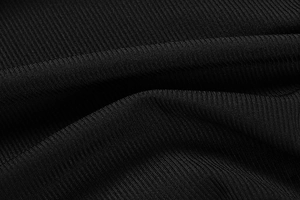 Macro shot of high-quality black ribbed knit fabric texture on a slim mini dress