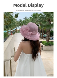 Detail of pink wide brim sun hat with large organza flower for summer beach vacations