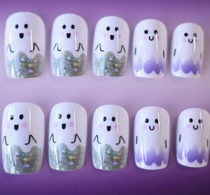 Detail of Halloween ghost press-on nails with silver glitter and purple wavy patterns