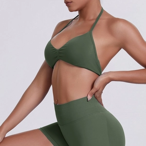 Close-up of olive green seamless halter sports bra and high waist ribbed yoga shorts set
