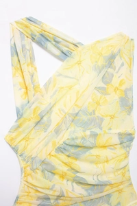 Detail of yellow floral mesh bodysuit featuring asymmetrical pleats and mesh texture