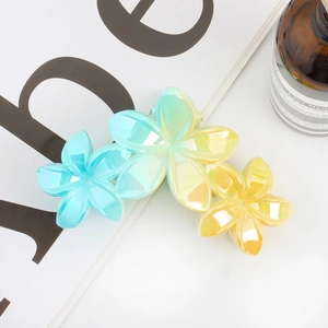 Detailed close-up of a gradient floral hair claw clip with a matte resin finish
