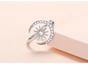 Macro side view of adjustable silver sun and moon ring with micro-pave zircons