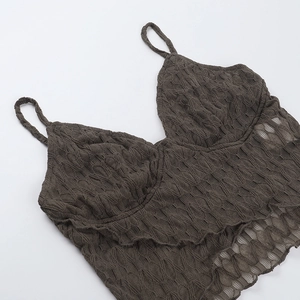 Detailed close-up showing textured knit fabric and lace pattern of the V-neck camisole