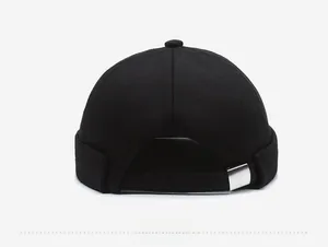 Detail view of the silver metal adjustable buckle and stitching on the black cotton docker cap