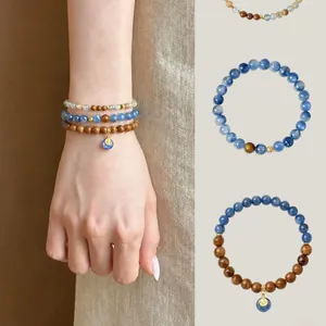 Bohemian multilayer beaded bracelet set with blue stones, wood beads and metal charms