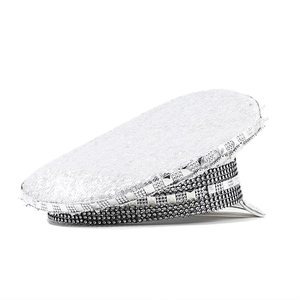 Close-up of glitter sequins and silver square studs on a sparkly captain hat for parties