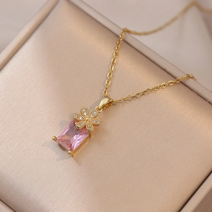 Elegant gold necklace with pink rectangular gemstone pendant and floral zircon details