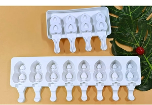 Flat lay of 4 and 8-cavity white silicone heart-shaped popsicle molds for DIY ice cream