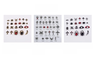 Macro detail of Gothic alloy nail art charms featuring spiders and skulls with rhinestones