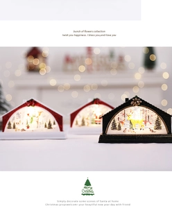 Close-up of three lighted Christmas snow globe lanterns with snowman and reindeer scenes