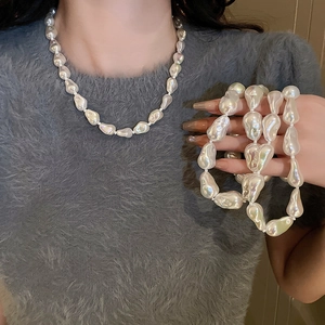 Detail of baroque pearl necklace with irregular pearls and iridescent luster on neck