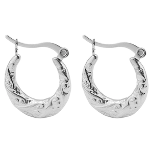 Detailed macro view of vintage silver hoop earrings with embossed vine pattern and curved pins