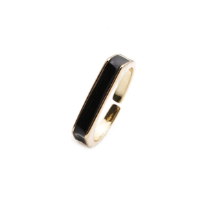 Detailed macro view of an open adjustable gold-plated ring with black enamel rectangle