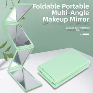 Detail view of the mint green foldable vanity mirror showing its multi-angle design