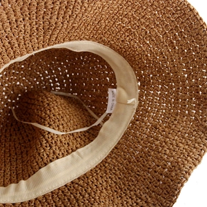 Detail of hand-woven straw hat showing interior sweatband and adjustable drawstring