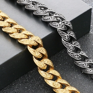 Macro detail of punk retro 13mm Cuban chain with intricate floral patterns in gold and silver