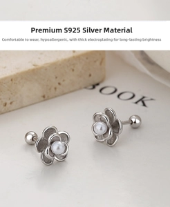 Macro shot of 925 sterling silver camellia flower earrings with center pearl detail