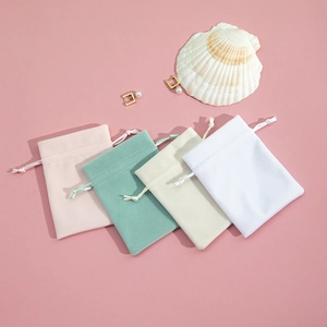 Detailed plush drawstring pouches in pastel colors for jewelry storage and gifting